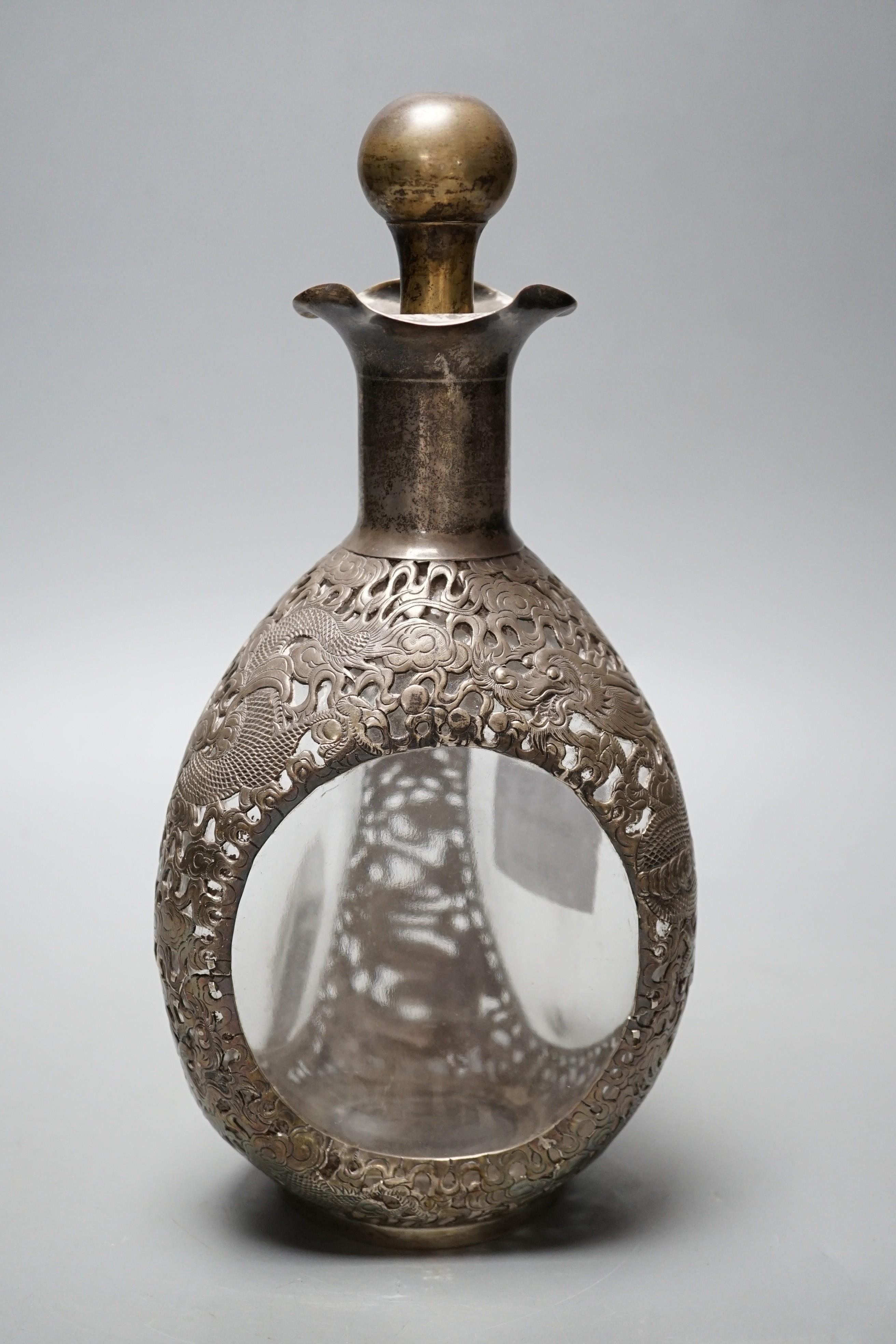 A Chinese white metal mounted glass 'dimple' decanter and stopper, by Wang Hing, Hong Kong, 26.5cm.